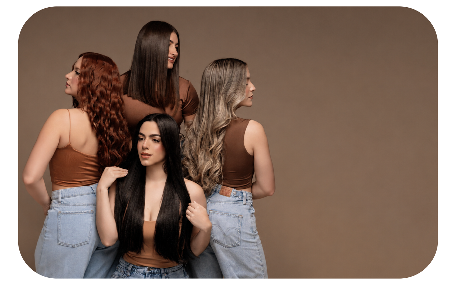Four women with long hair in brown crop tops and jeans showcase diverse hair colors and styles against a brown background.