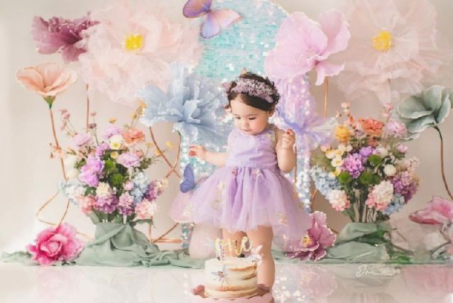 A series of pastel-colored cake smash photos with floral decorations and butterflies against a dreamy backdrop.