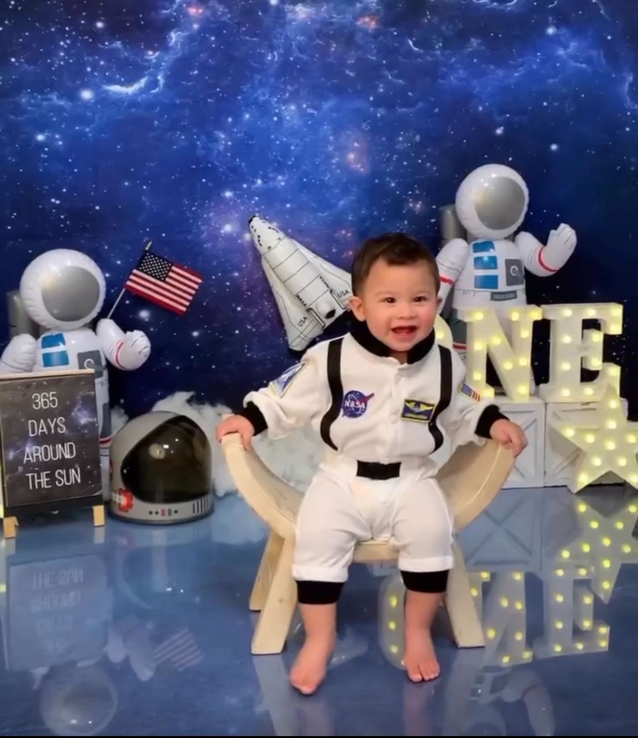 A series of space-themed baby photos with astronaut costumes and celestial backdrop showing progression of growth.