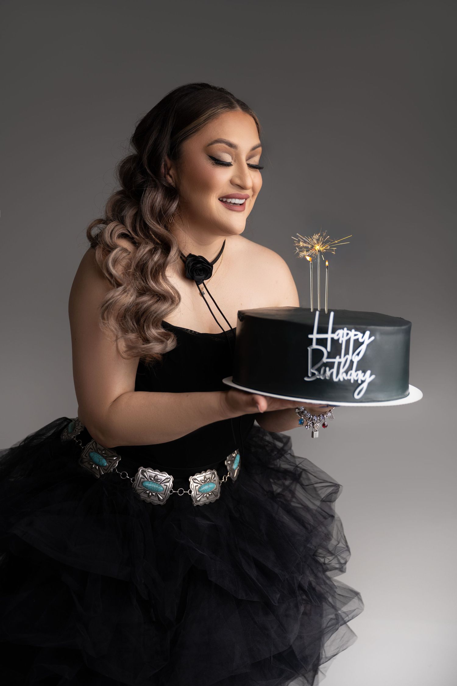Elegant birthday photoshoot with black tulle dress and sparkler cake.
