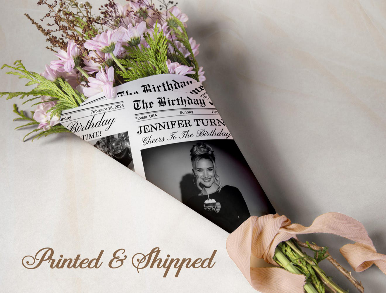 Personalized birthday flower bouquet wrapped in custom newspaper print featuring Jennifer's photo and name.