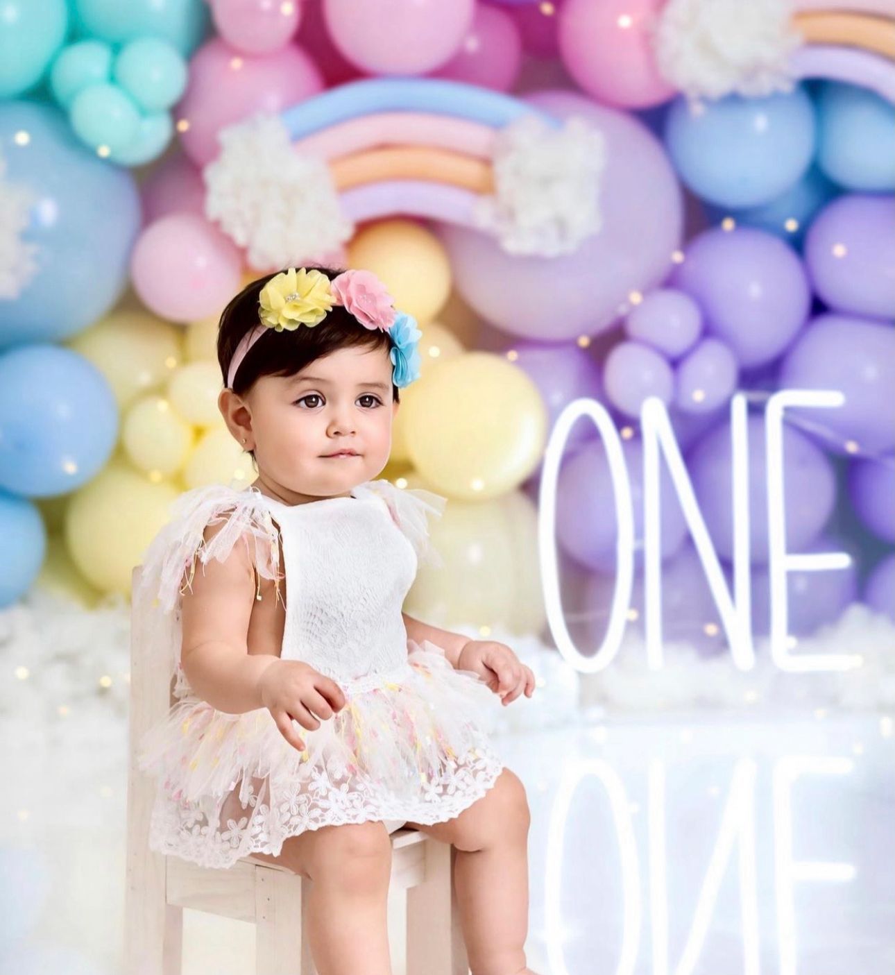 Soft pastel balloon backdrop with delicate colors in pink, blue, yellow and purple creating a dreamy atmosphere.