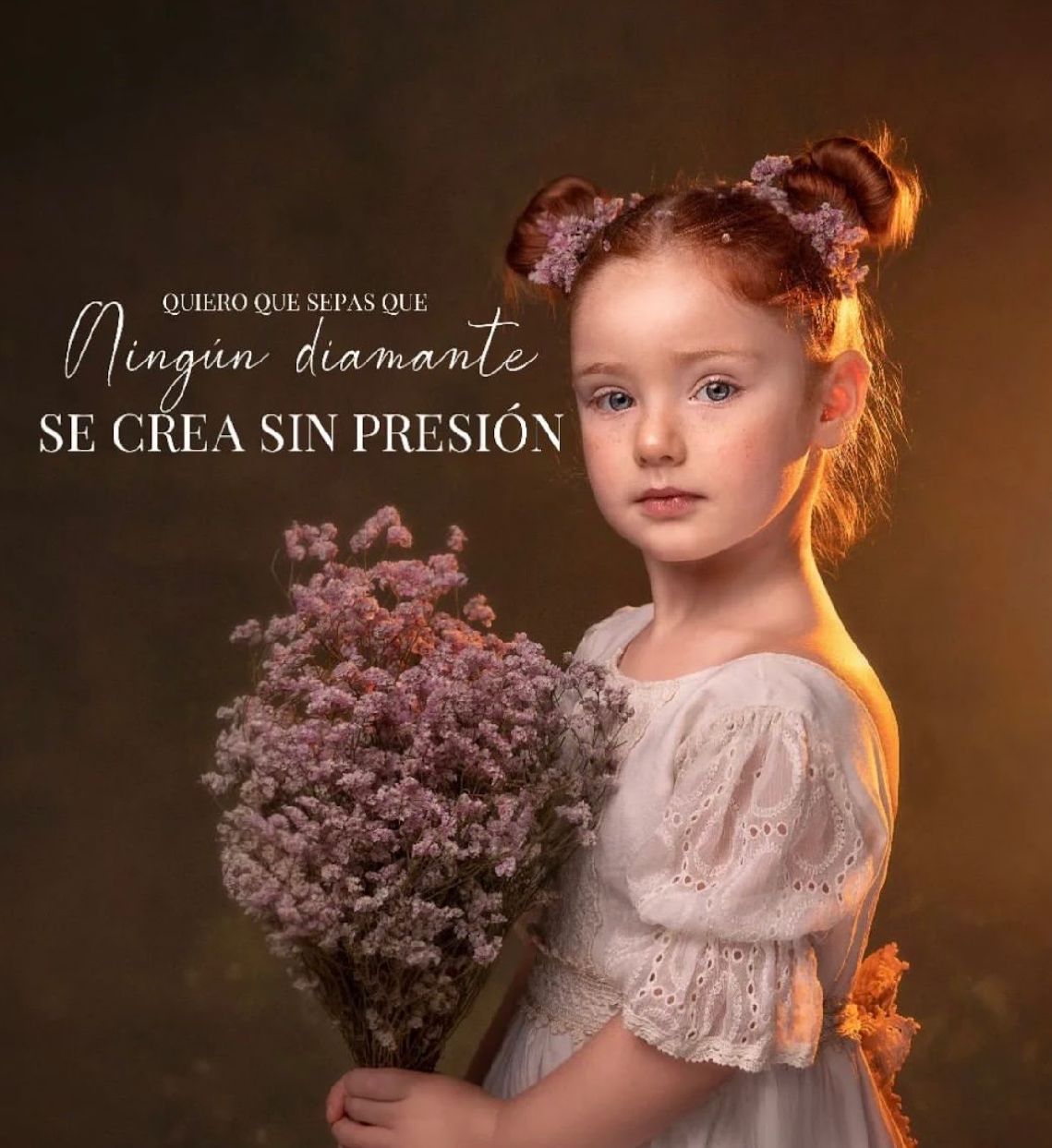 Ethereal portrait of a young subject in white lace dress holding dried purple flowers with warm dramatic lighting.