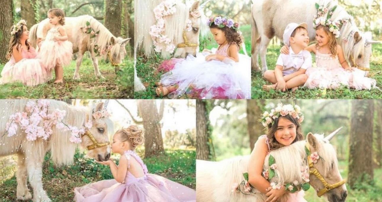 Young girl in pink tutu dress poses with a white unicorn in a dreamy outdoor floral fantasy photo session.