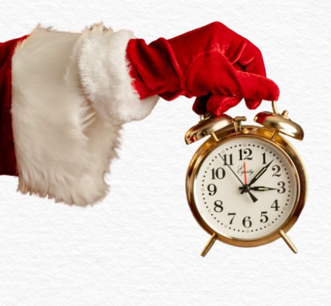 A sequence of vintage-style red alarm clocks and white tissue paper decorations arranged in a repeating pattern.