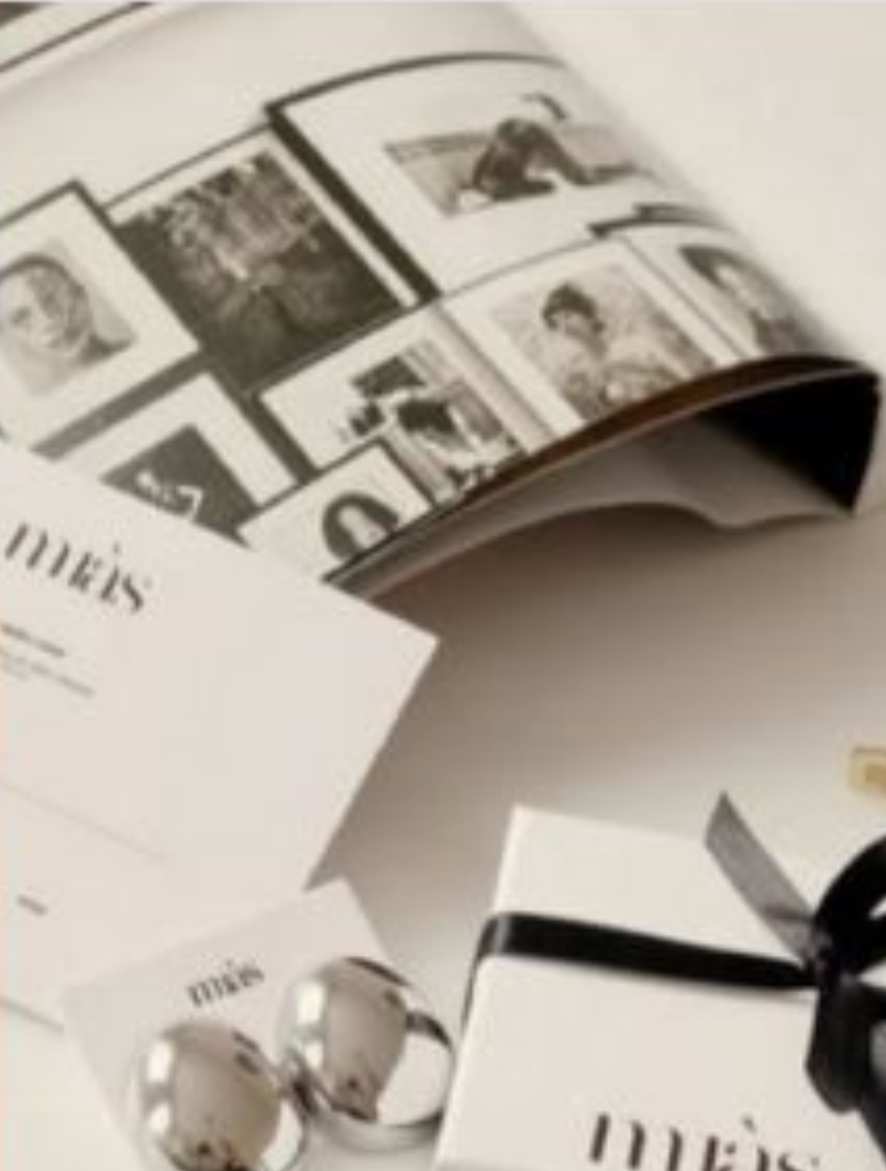 Elegant Meis brand jewelry catalog with black and white photos, silver rings, and a gift box with black ribbon.