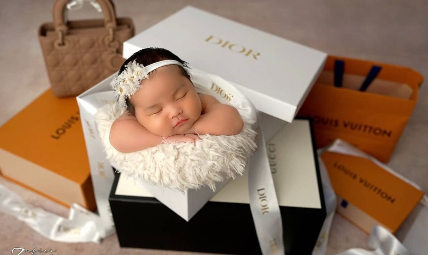 Luxury Louis Vuitton shopping bags and boxes arranged on white surface with tissue paper and ribbons.