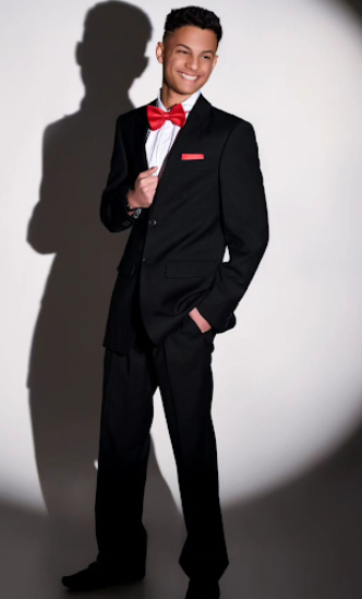 Professional studio portraits featuring classic black tuxedo with red bow tie against white background.