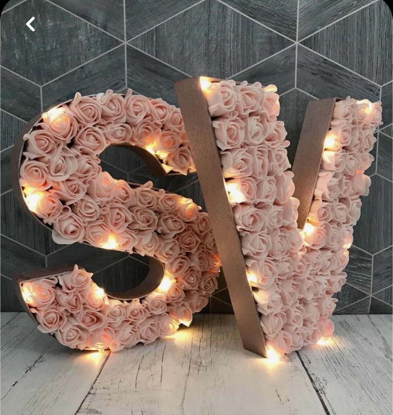 Light-up marquee letters S and Y decorated with pink roses and warm fairy lights for weddings.