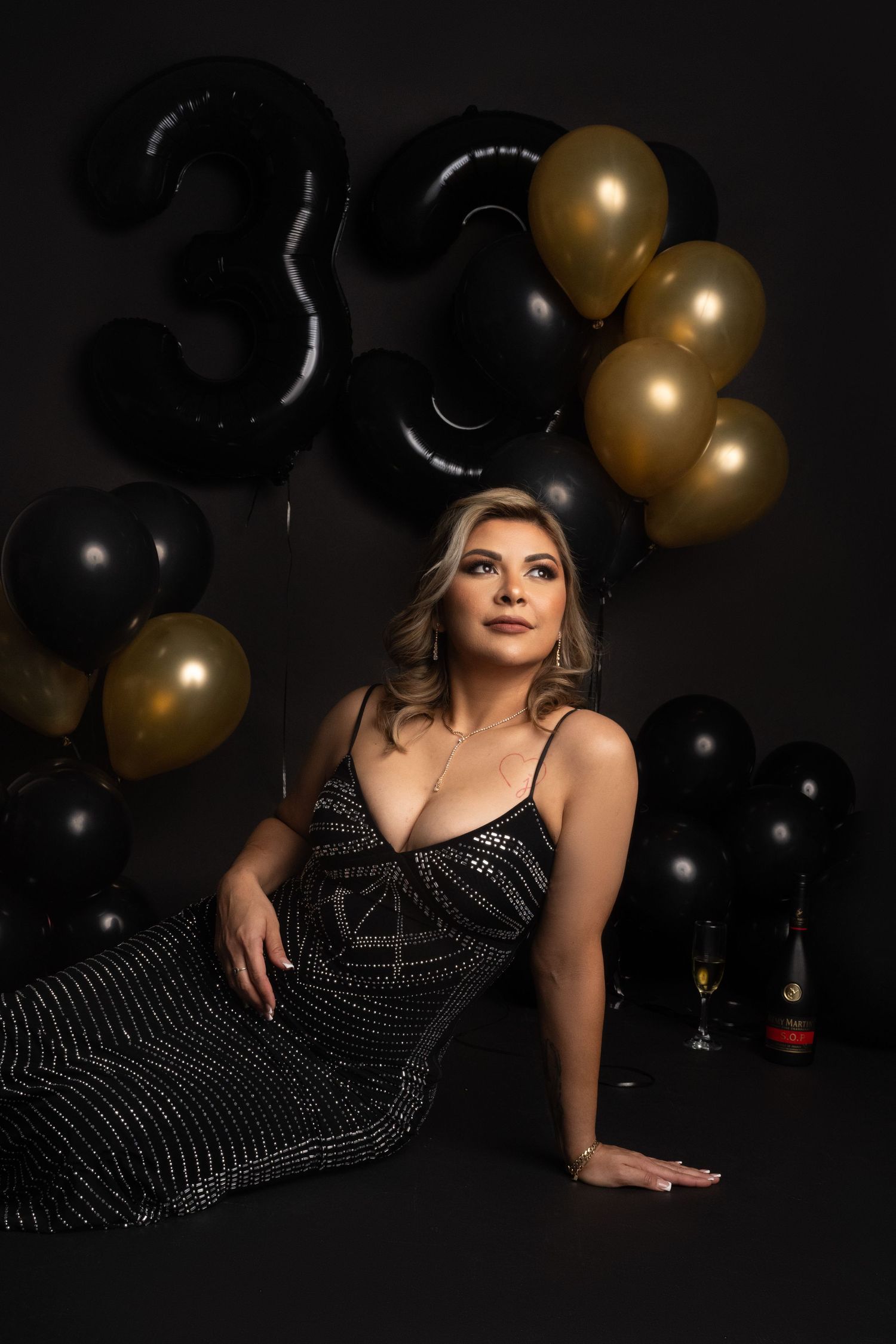 Birthday celebration setup with number 30 balloons in black and gold theme.