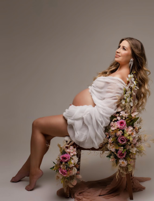 Artistic boudoir photo series with white fabric and floral arrangements creating ethereal romantic compositions.