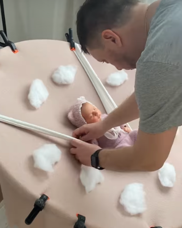 Students arrange cotton balls and straws on a table during a hands-on STEM activity.