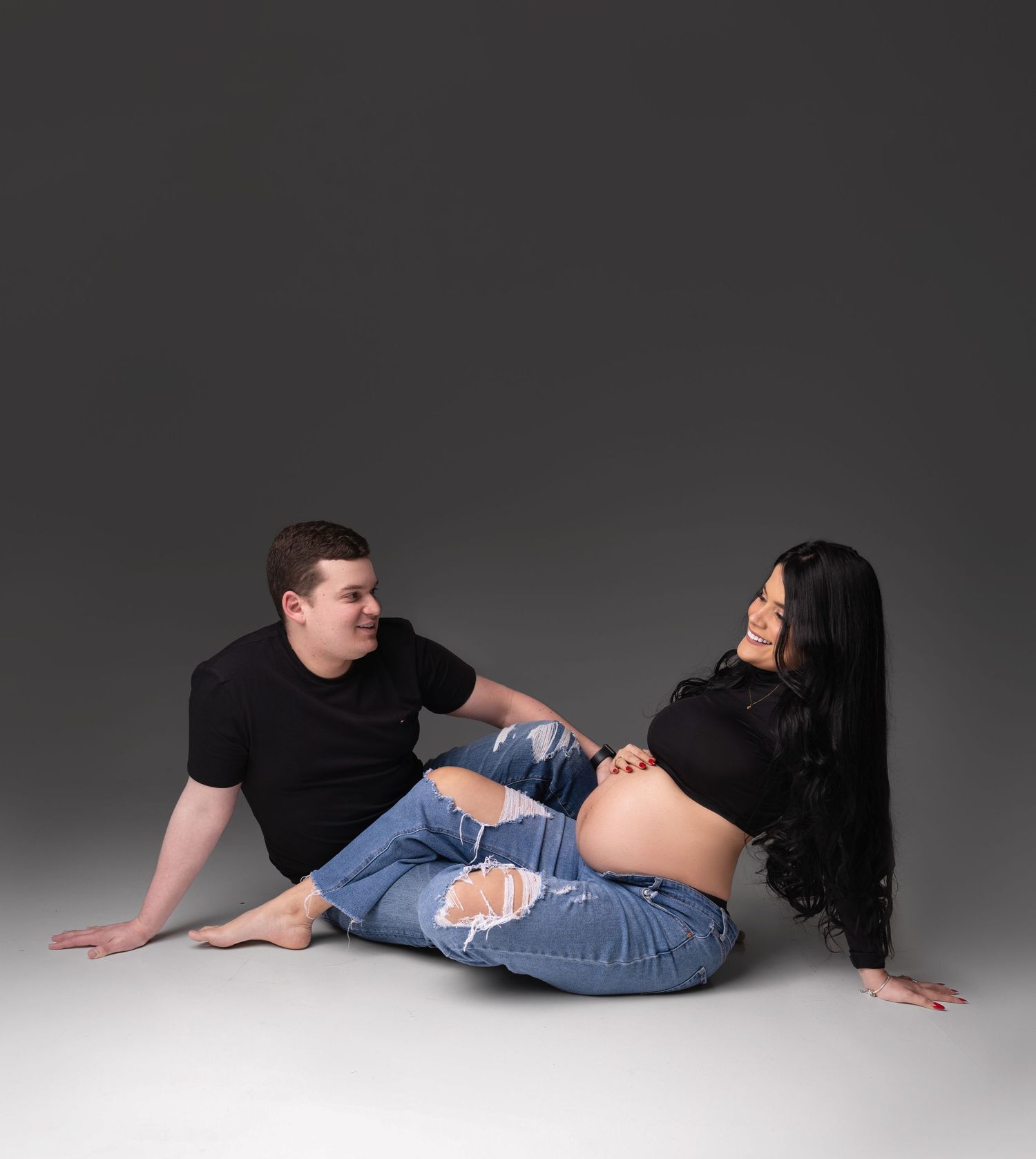 A sequence of poses showing a person lying on the ground and rolling from side to side in a studio setting.