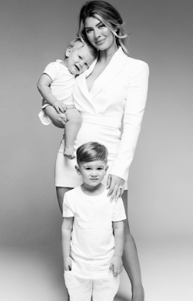A series of black and white portraits showing tender moments between parent and child in matching white outfits.