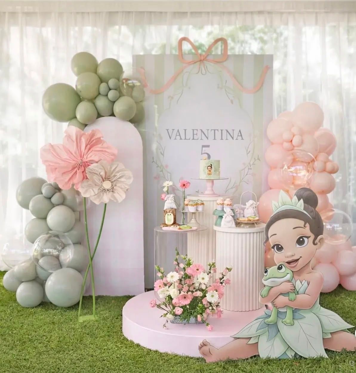 Princess Tiana themed 5th birthday party setup with pink and green balloons, floral decorations, and a personalized backdrop for Valentina.