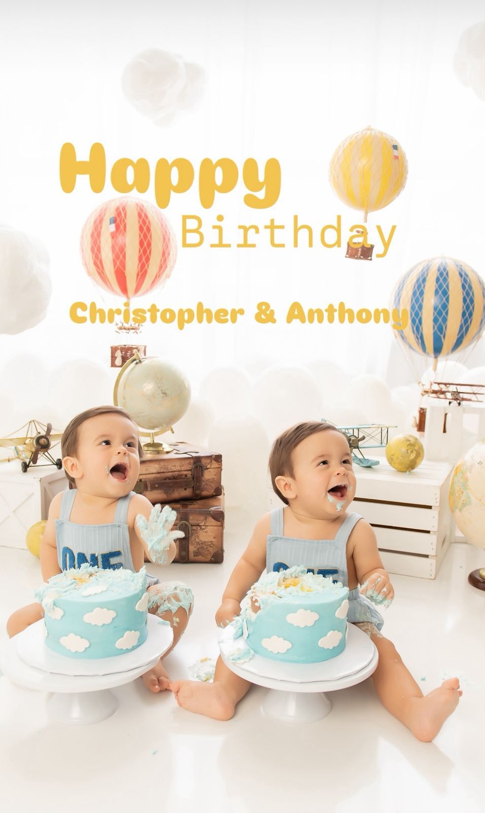 Cake smash photo session with blue and white cloud-themed birthday cake and festive decorations.