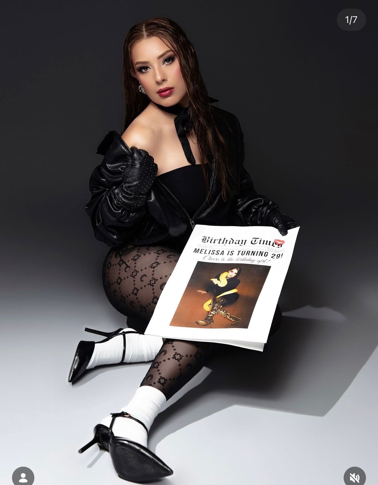 Young woman in black outfit holding a Birthday Times newspaper celebrating Melissa turning 28.