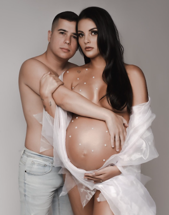 Artistic maternity photo series showing a couple in white clothing against a neutral grey background.