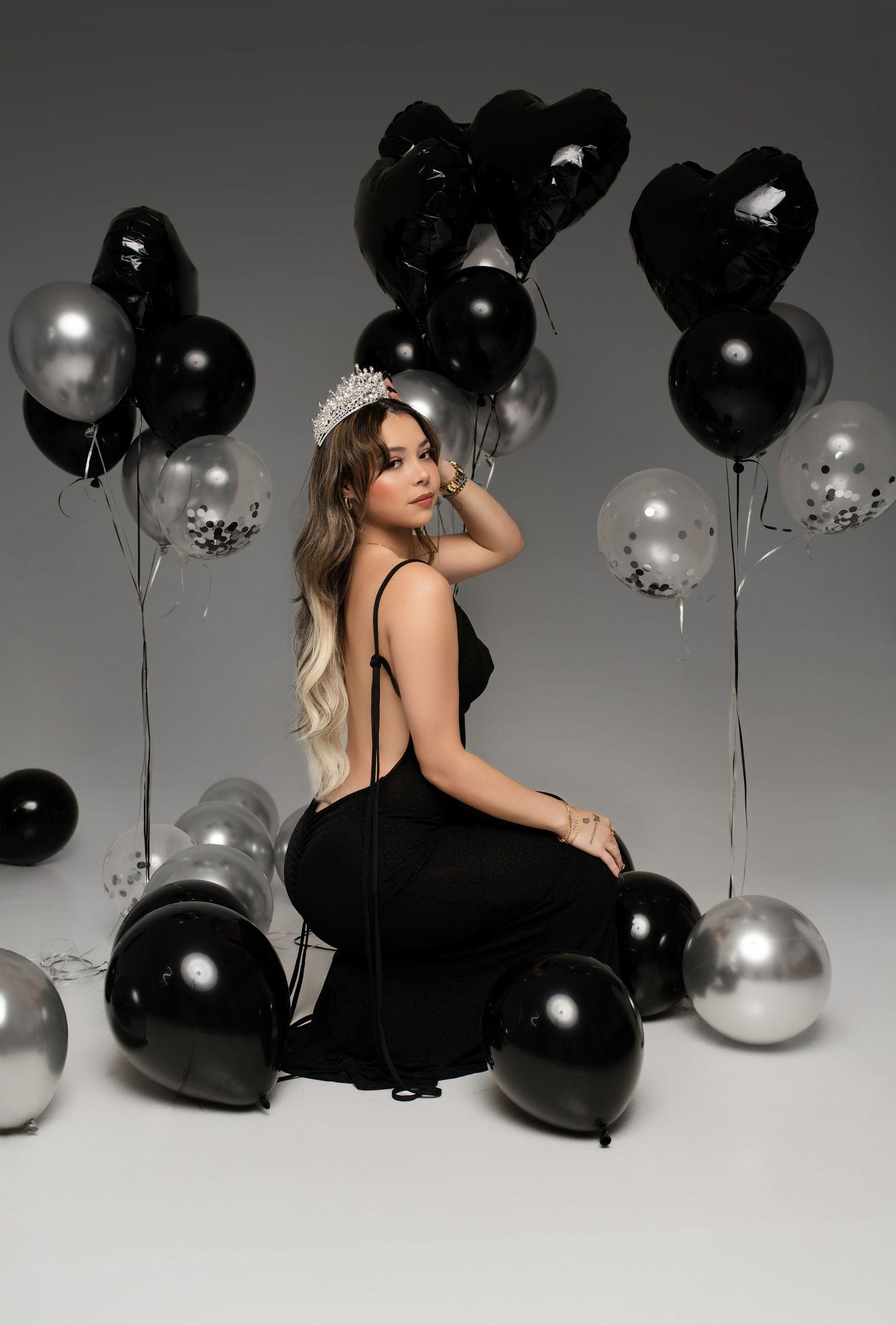 Artistic black and white photo series with black and silver balloons creating a moody, glamorous atmosphere.