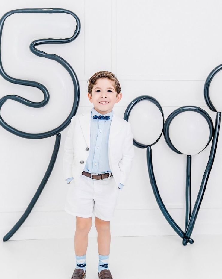 Black balloon numbers arranged against white background in minimalist style.