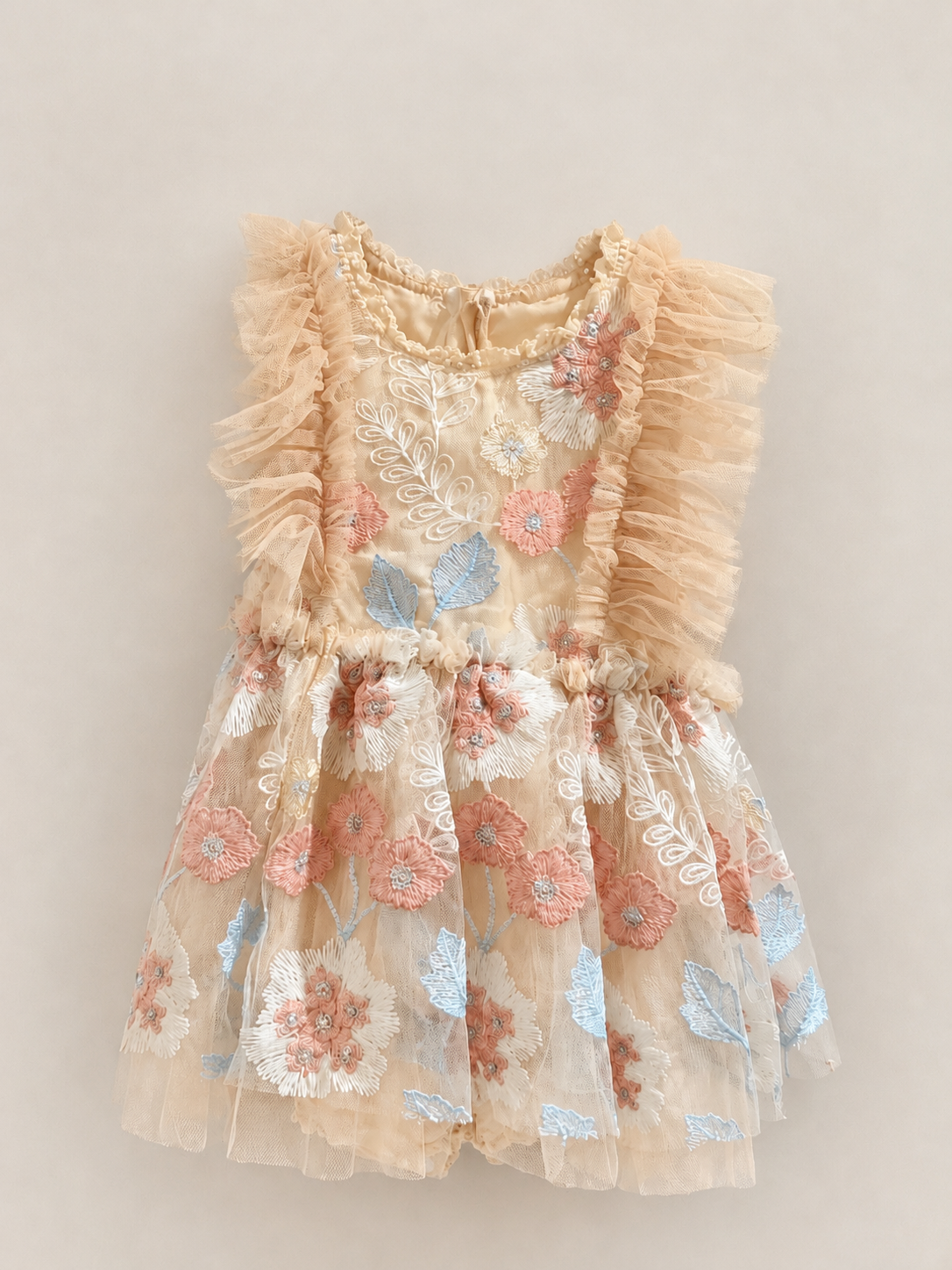 Girls peach tulle dress with ruffled shoulders and floral embroidery in coral, blue and white, perfect for special occasions.