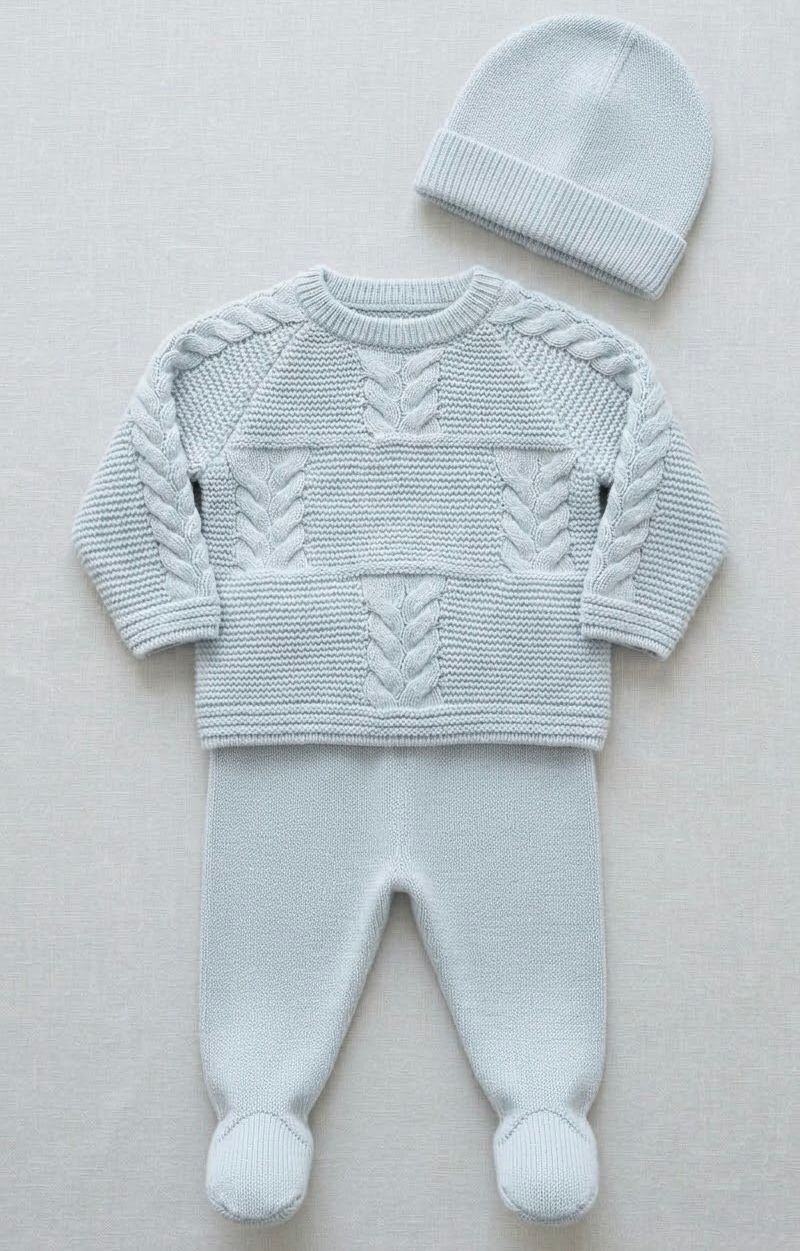 Light blue baby knit 3-piece set with cable-knit sweater, footed pants with pompoms, and matching beanie hat.