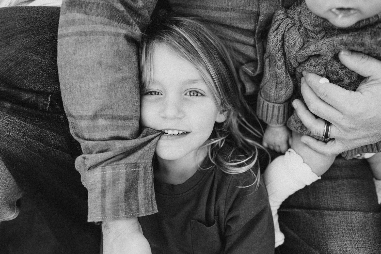 Black and white close-up portrait showing genuine joy and connection.