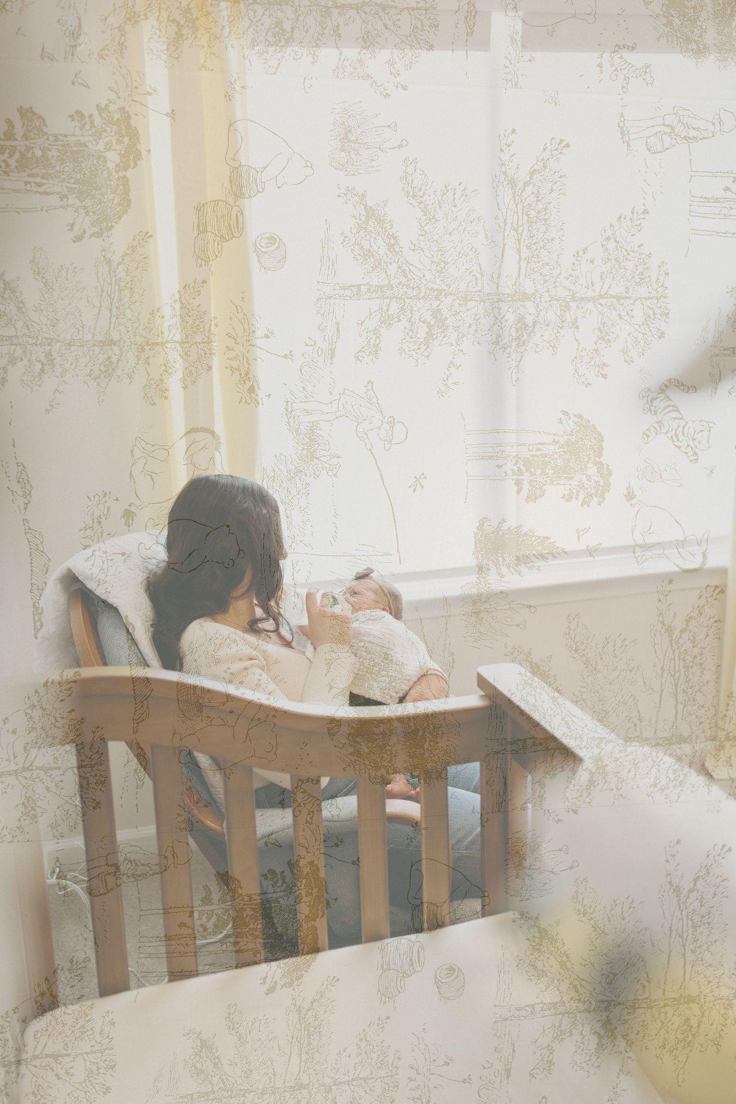 A dreamy vintage-style photo of a mother and baby resting together in a wooden rocking chair.