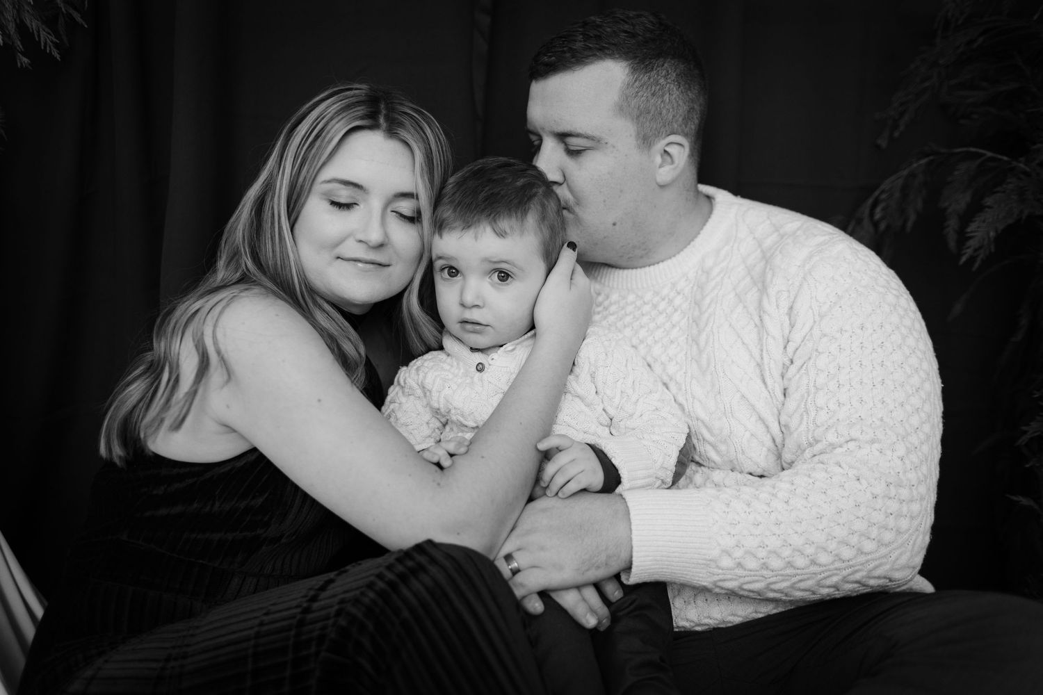 Black and white family portrait showing intimate moment together.