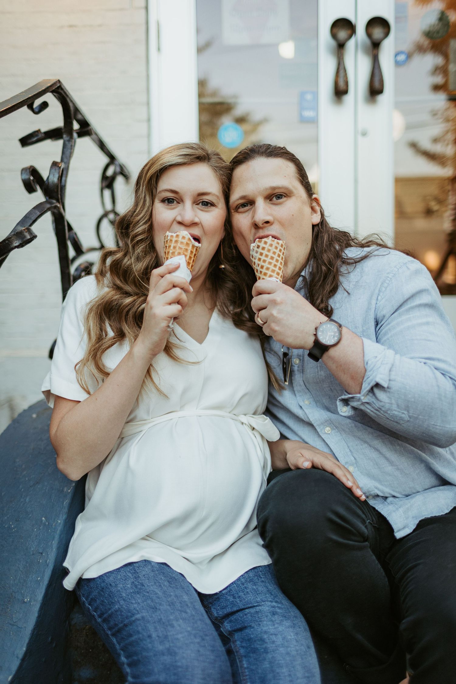 Two people sharing a moment while eating ice cream cones together.