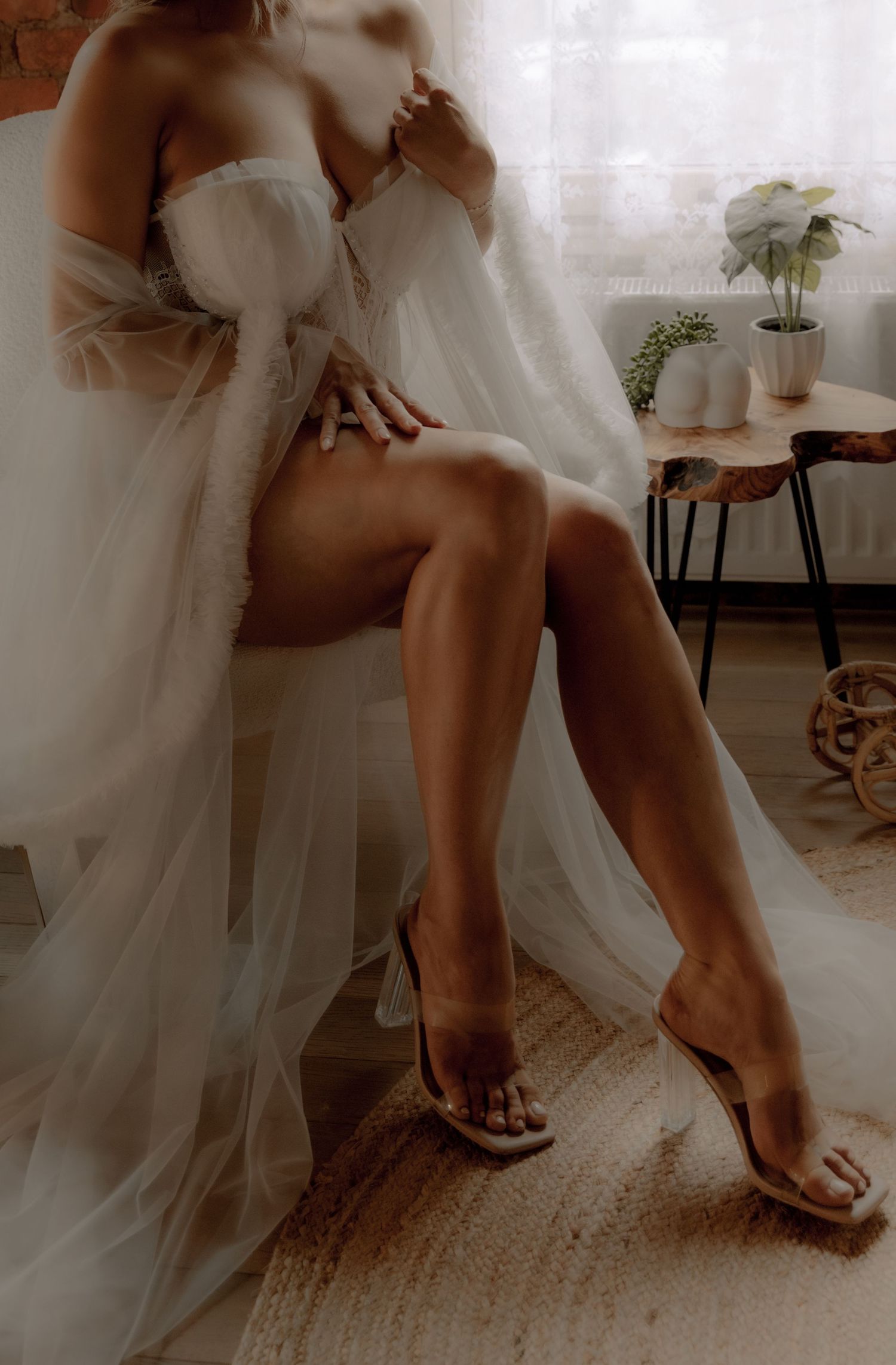 Intimate portrait with delicate white fabric in a naturally lit rustic setting.