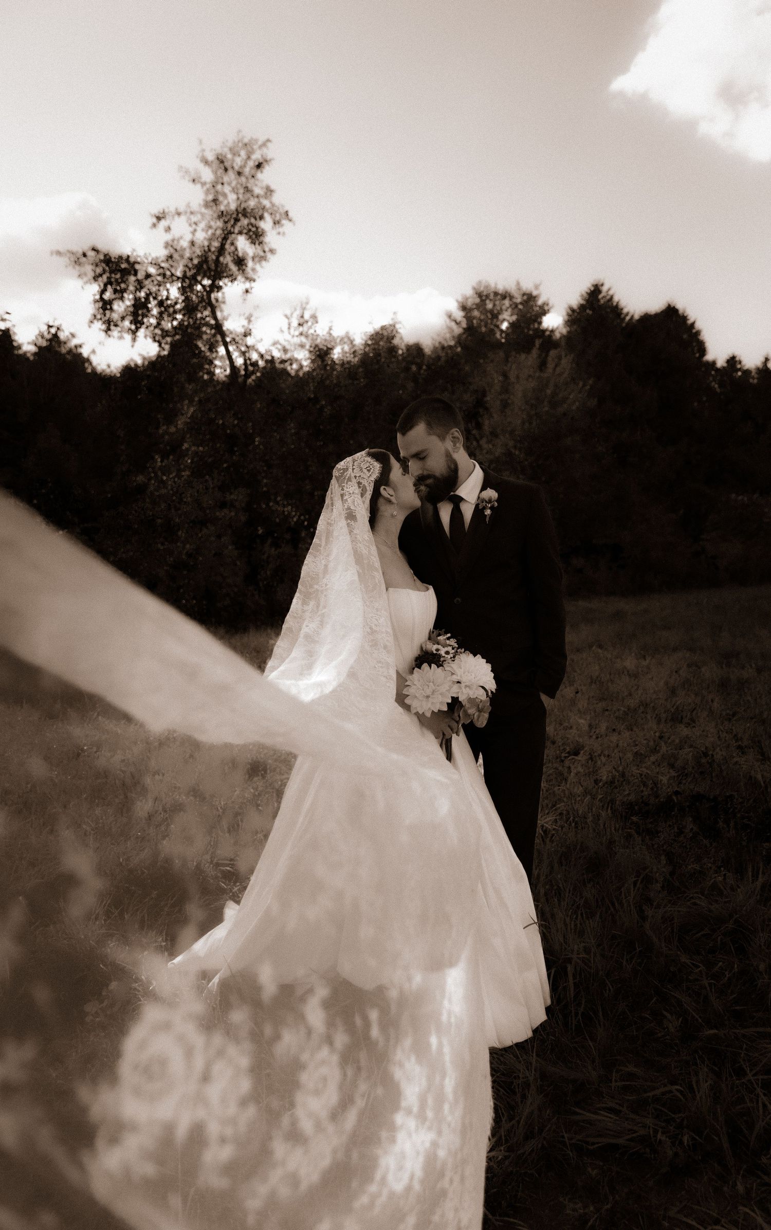 A romantic black and white photo series showing a bride and groom embracing in an outdoor setting with soft dreamy effects.