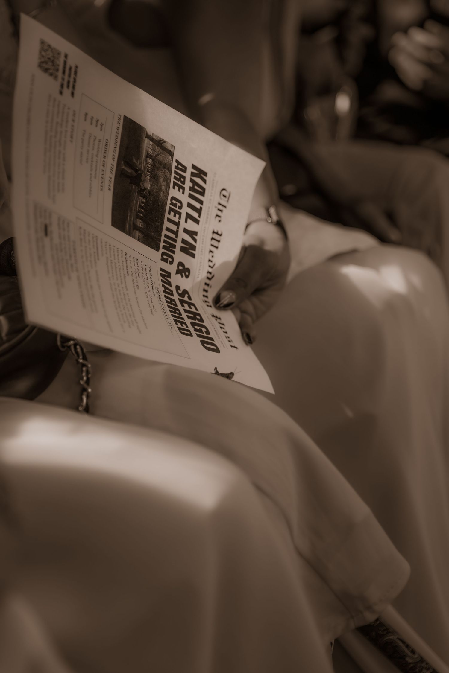 Sepia-toned photograph of someone reading a newspaper.