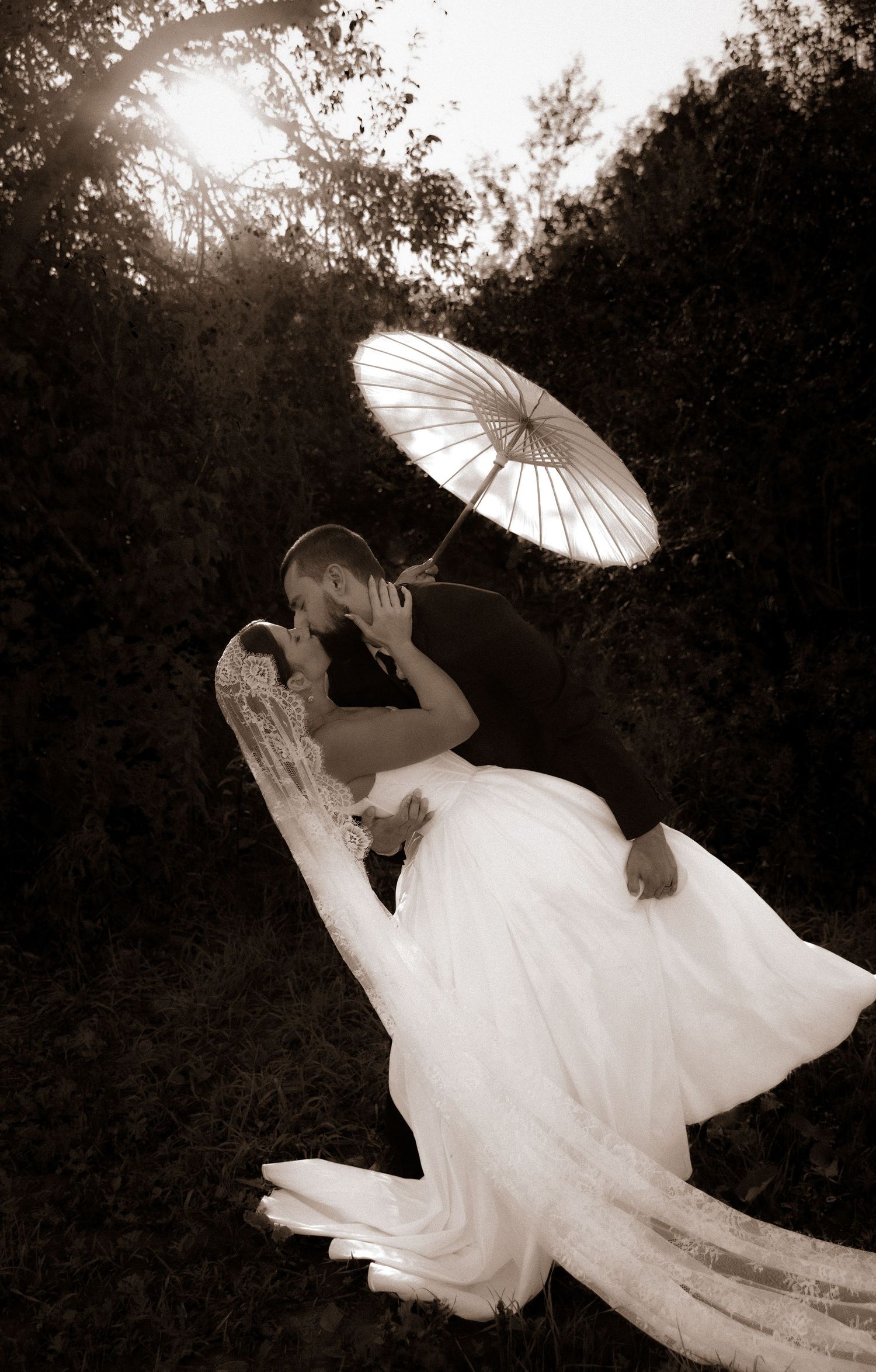 A figure in a flowing white dress and parasol creates an ethereal silhouette in a series of artistic black and white photos.