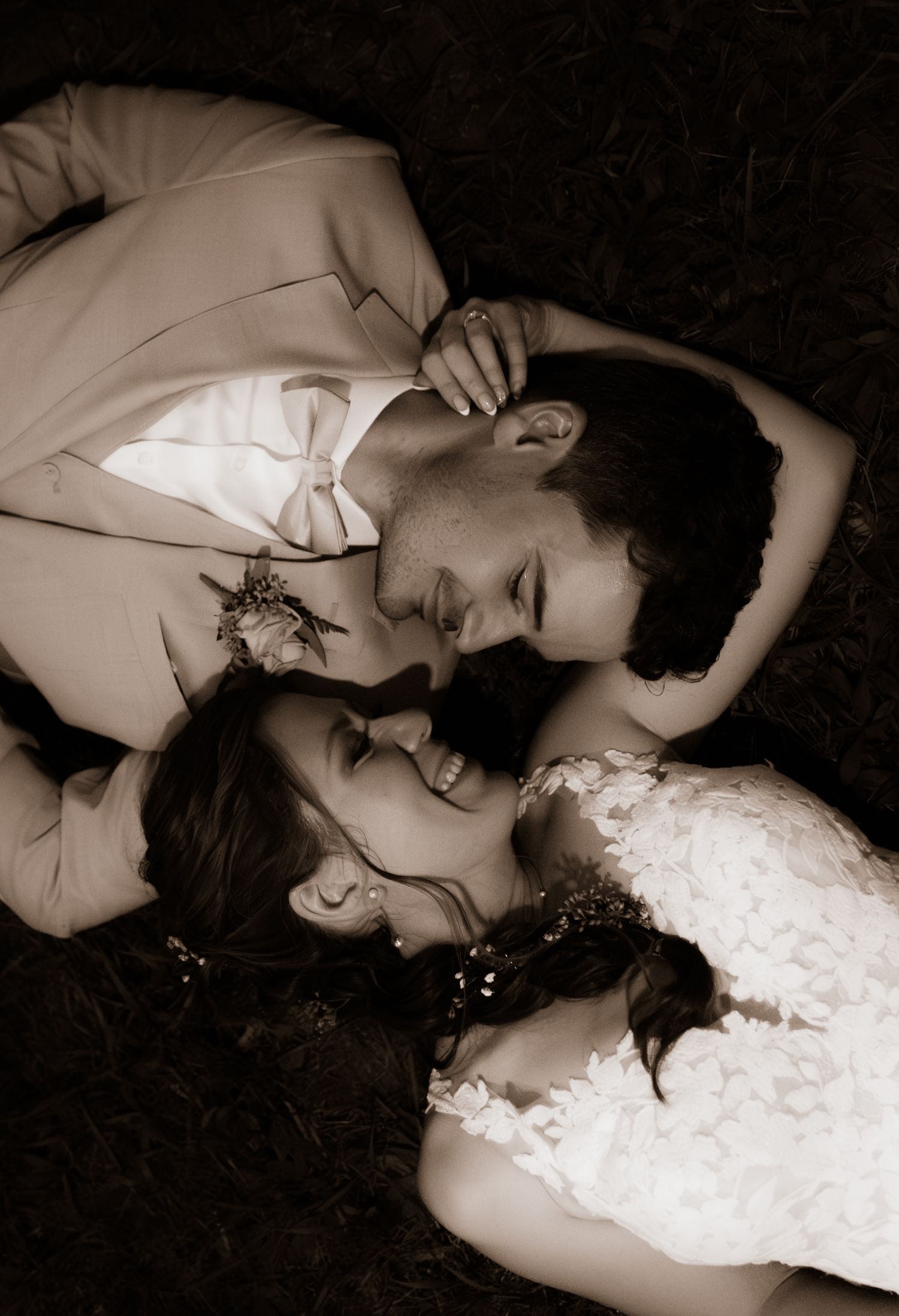 A series of artistic black and white photographs showing a person lying down in romantic poses with dramatic lighting.