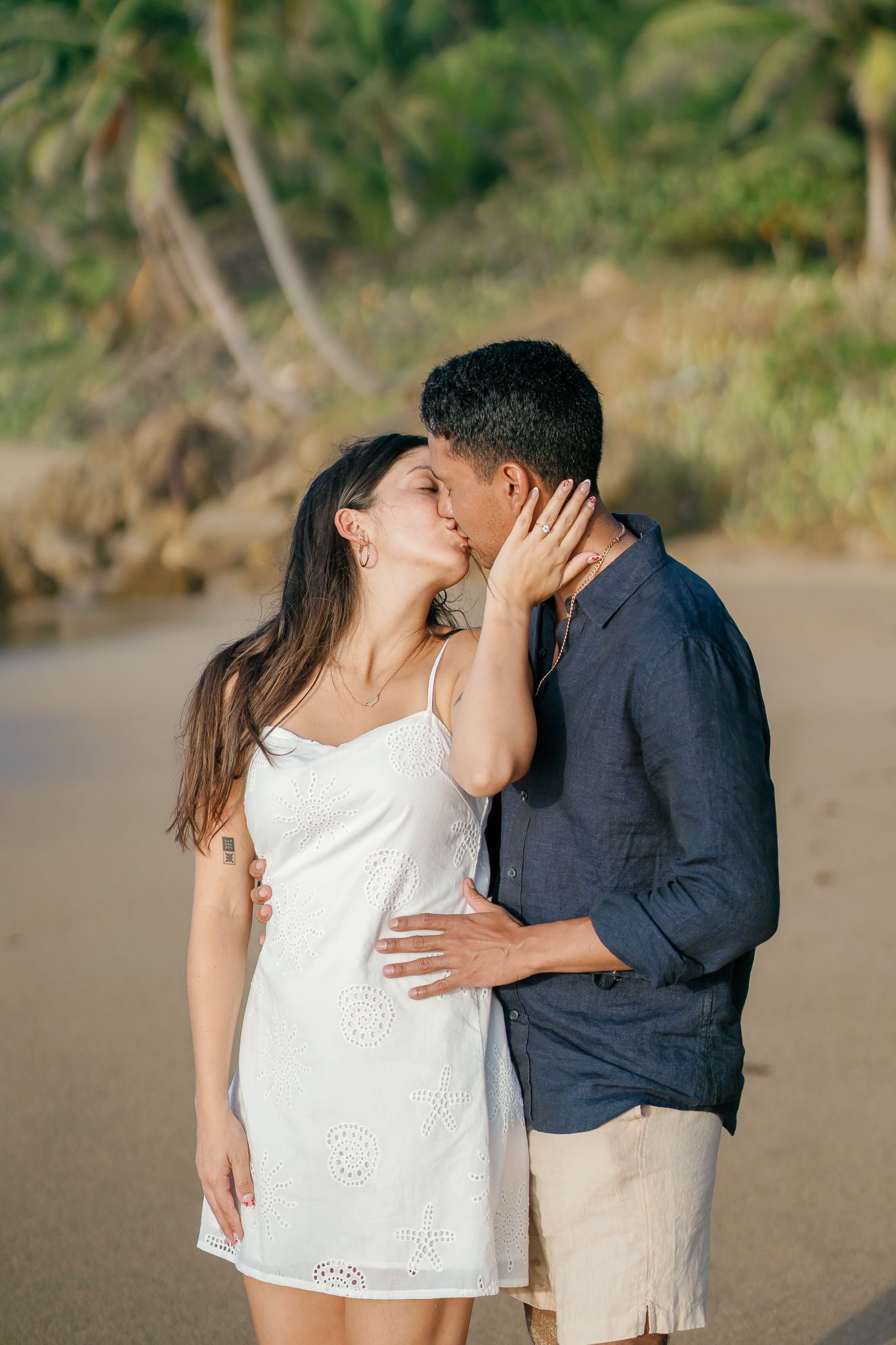 A romantic sequence of photos showing a couple sharing tender moments on a beach at sunset.