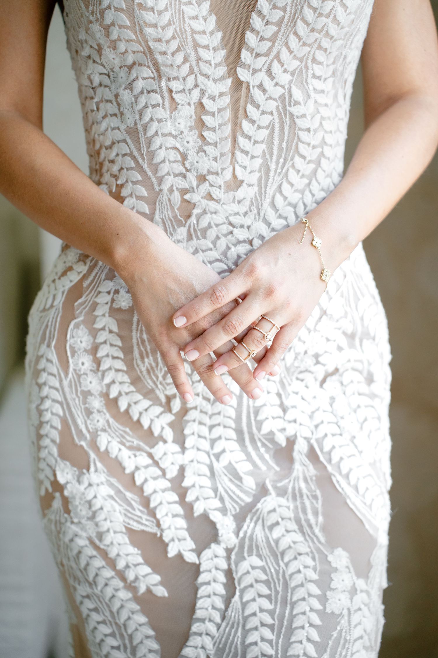 Close-up detail of intricate white lace pattern on wedding dress bodice.