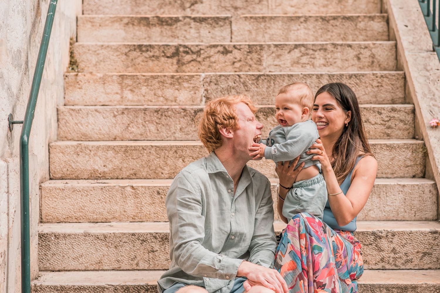 Parents and children sharing a joyful moment during a family session in Lisbon.