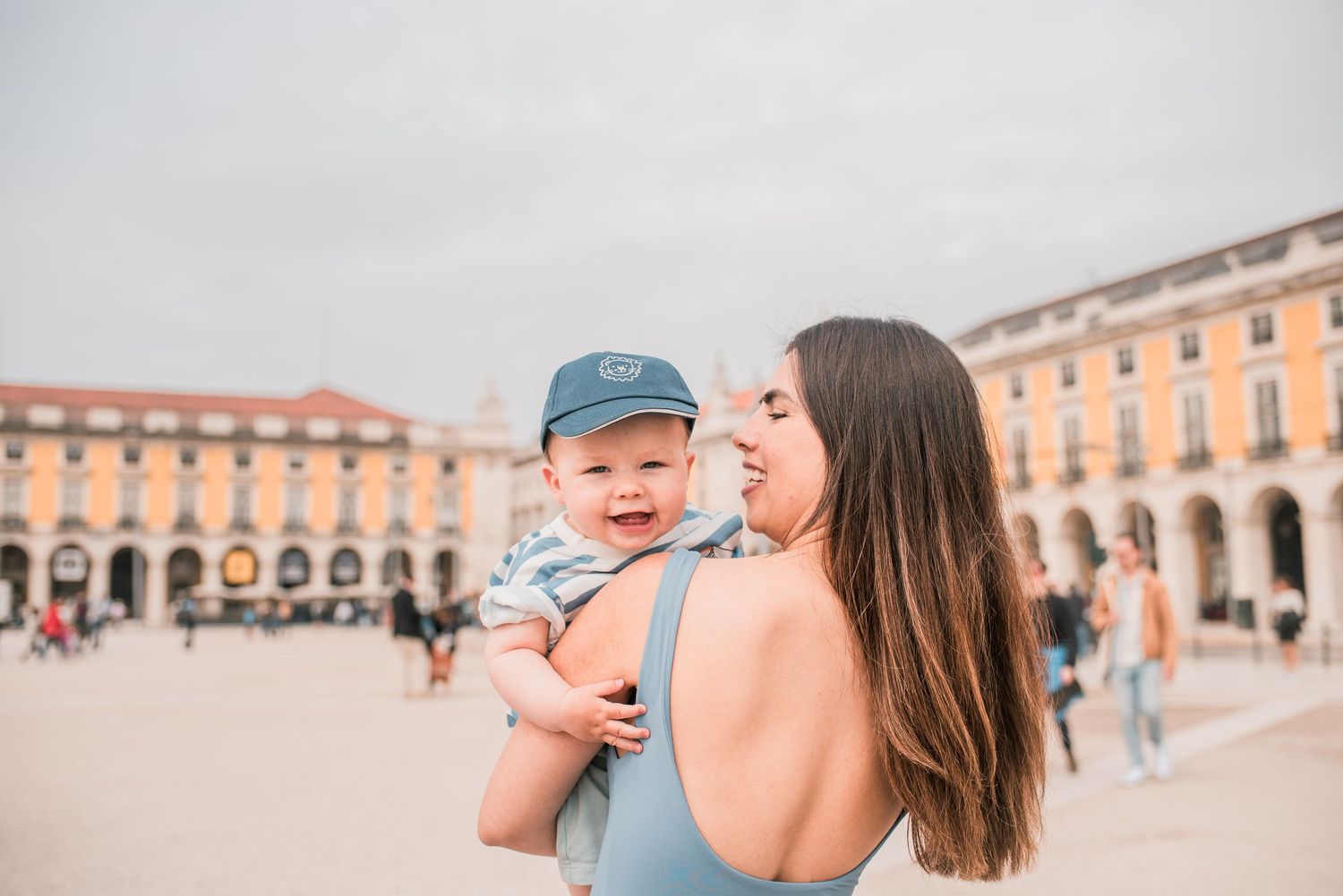 Parents and children sharing a joyful moment during a family session in Lisbon.