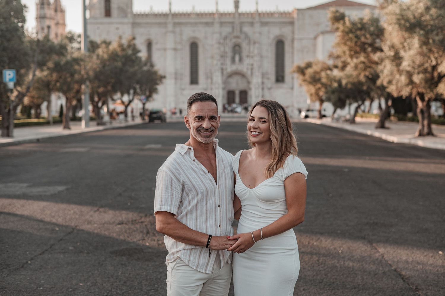 Engaged couple sharing an intimate moment in Belém, Lisbon, outdoor photography.