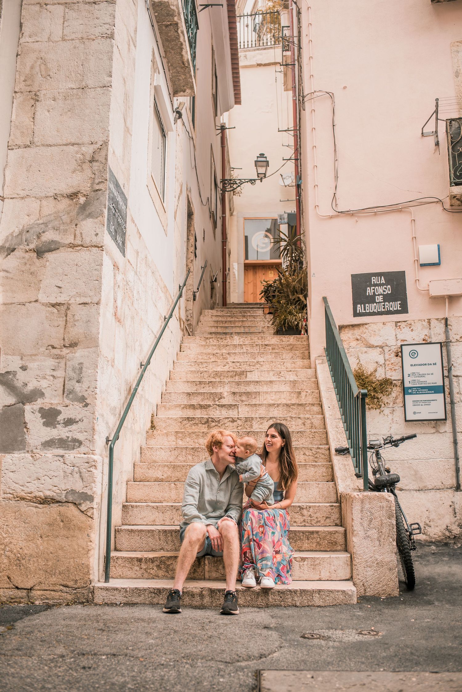 Parents and children sharing a joyful moment during a family session in Lisbon.