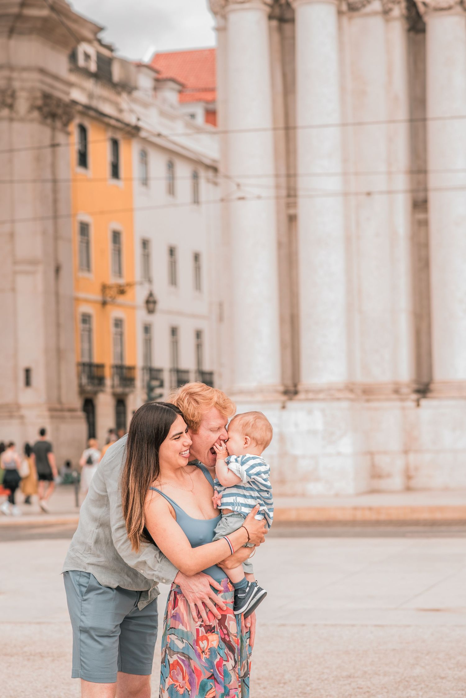 Parents and children sharing a joyful moment during a family session in Lisbon.