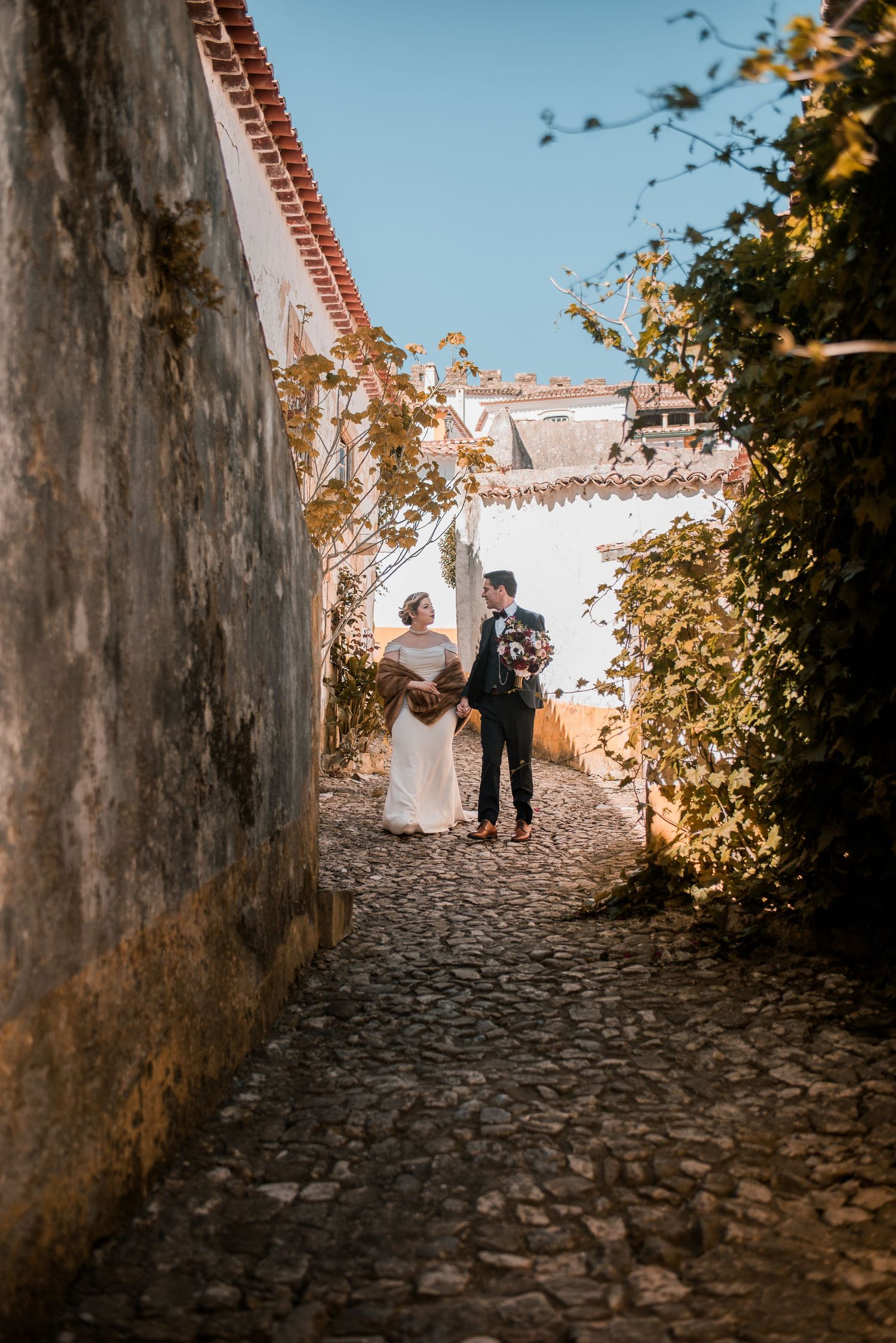 Romantic wedding portraits inside the medieval walls of Óbidos, Portugal.