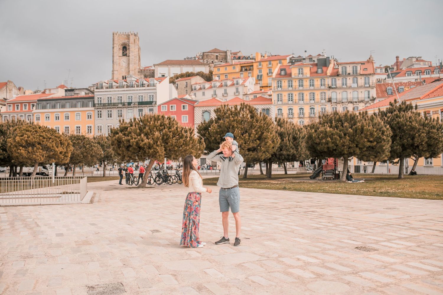 Parents and children sharing a joyful moment during a family session in Lisbon.