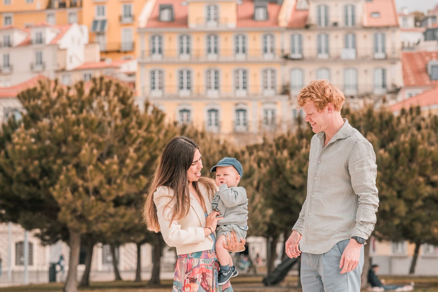 Parents and children sharing a joyful moment during a family session in Lisbon.