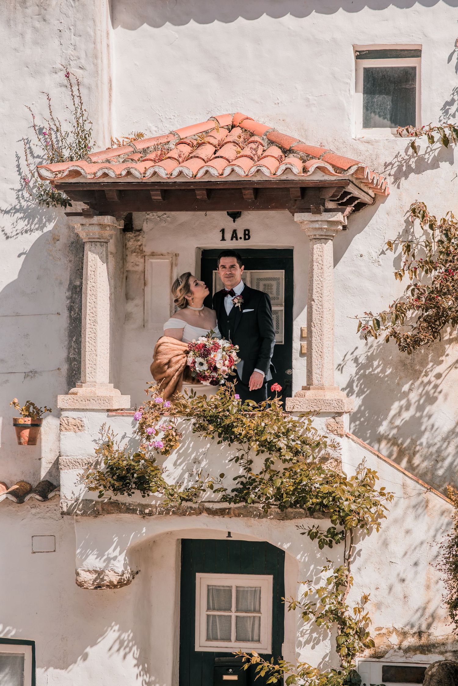 Bride and groom embracing in the historic streets of Óbidos during a destination wedding in Portugal.