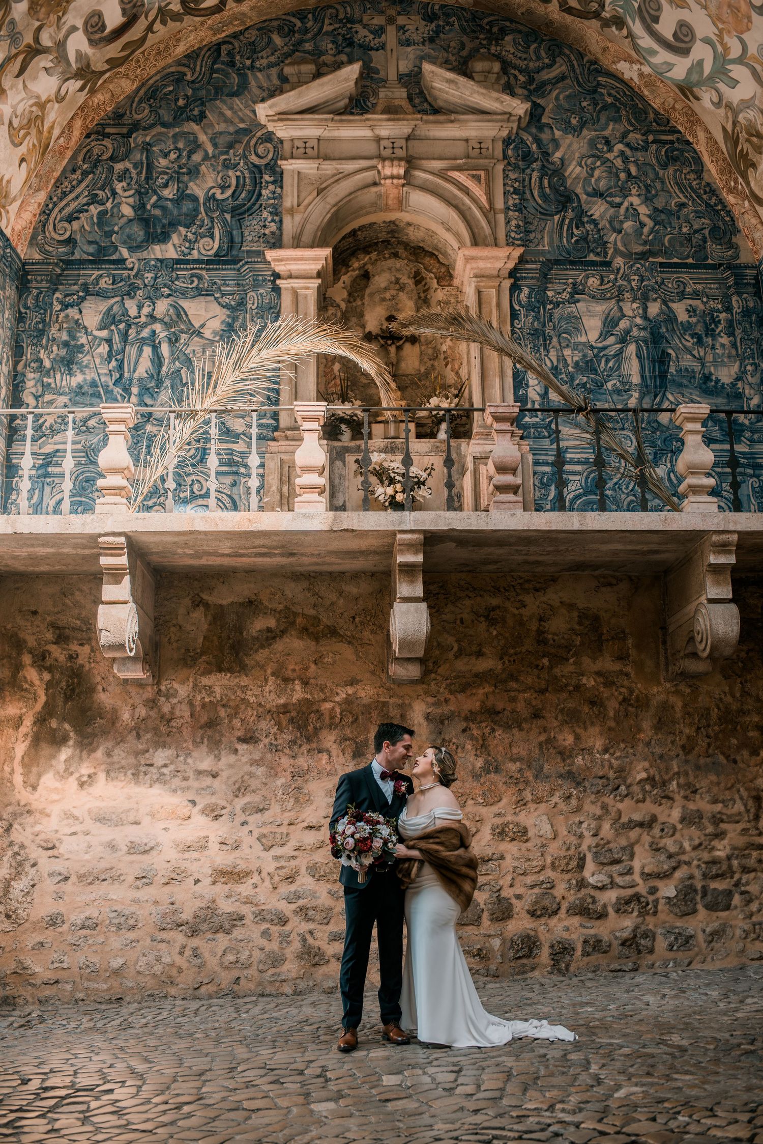 Destination wedding couple sharing a quiet moment in Óbidos, Portugal.