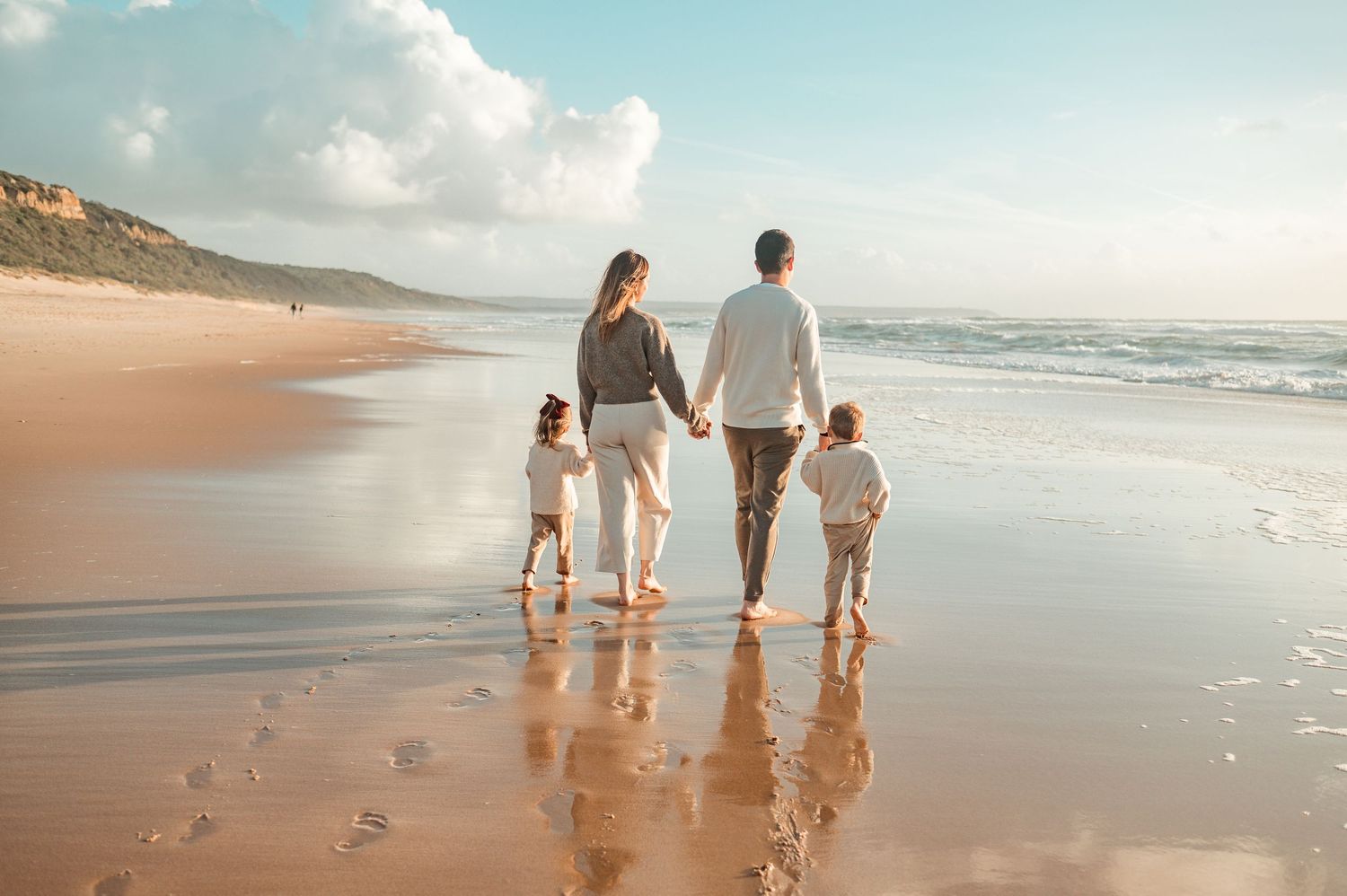Family photography session in the beach, Lisbon, with sunset light by the river.