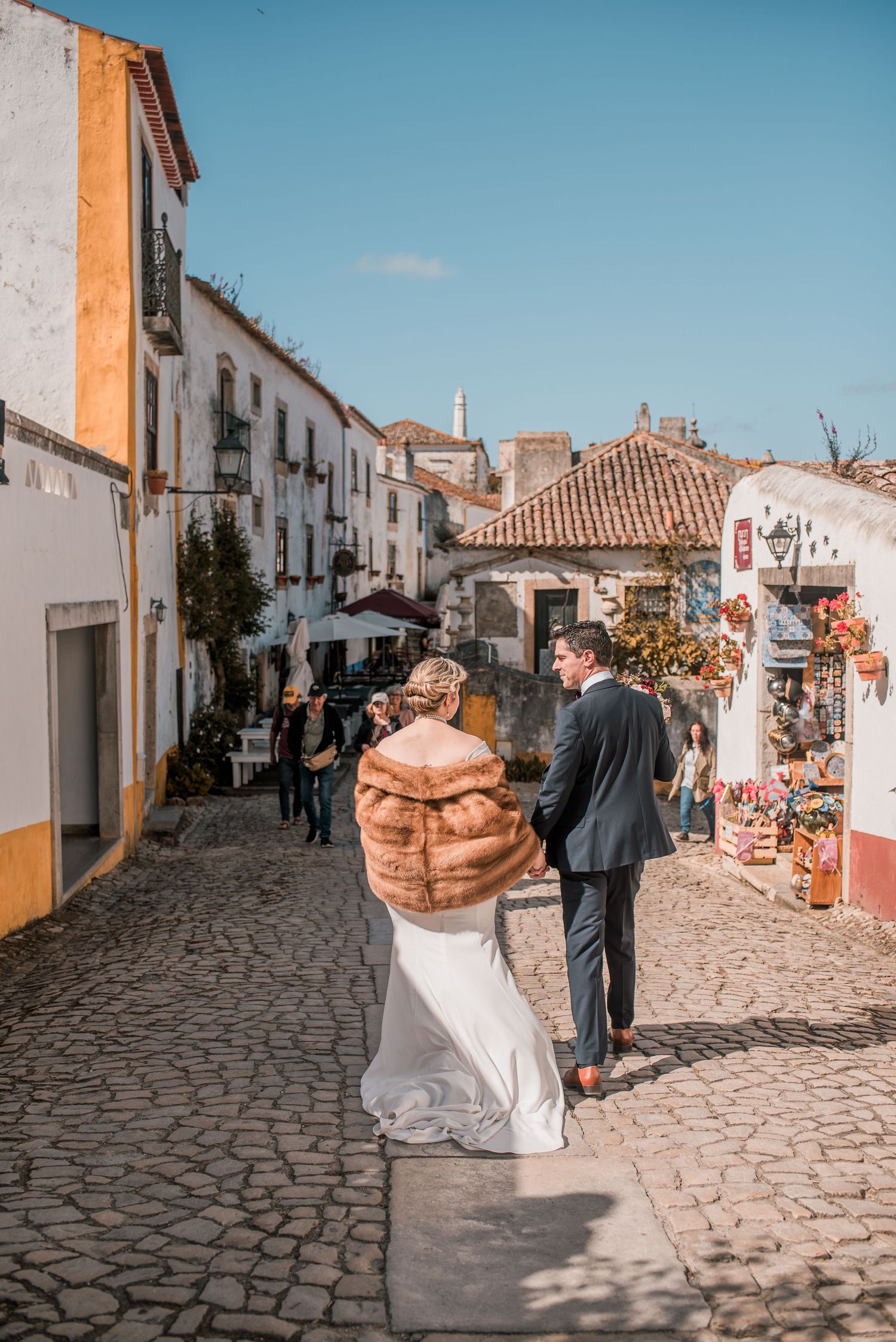 Destination wedding couple sharing a quiet moment in Óbidos, Portugal.