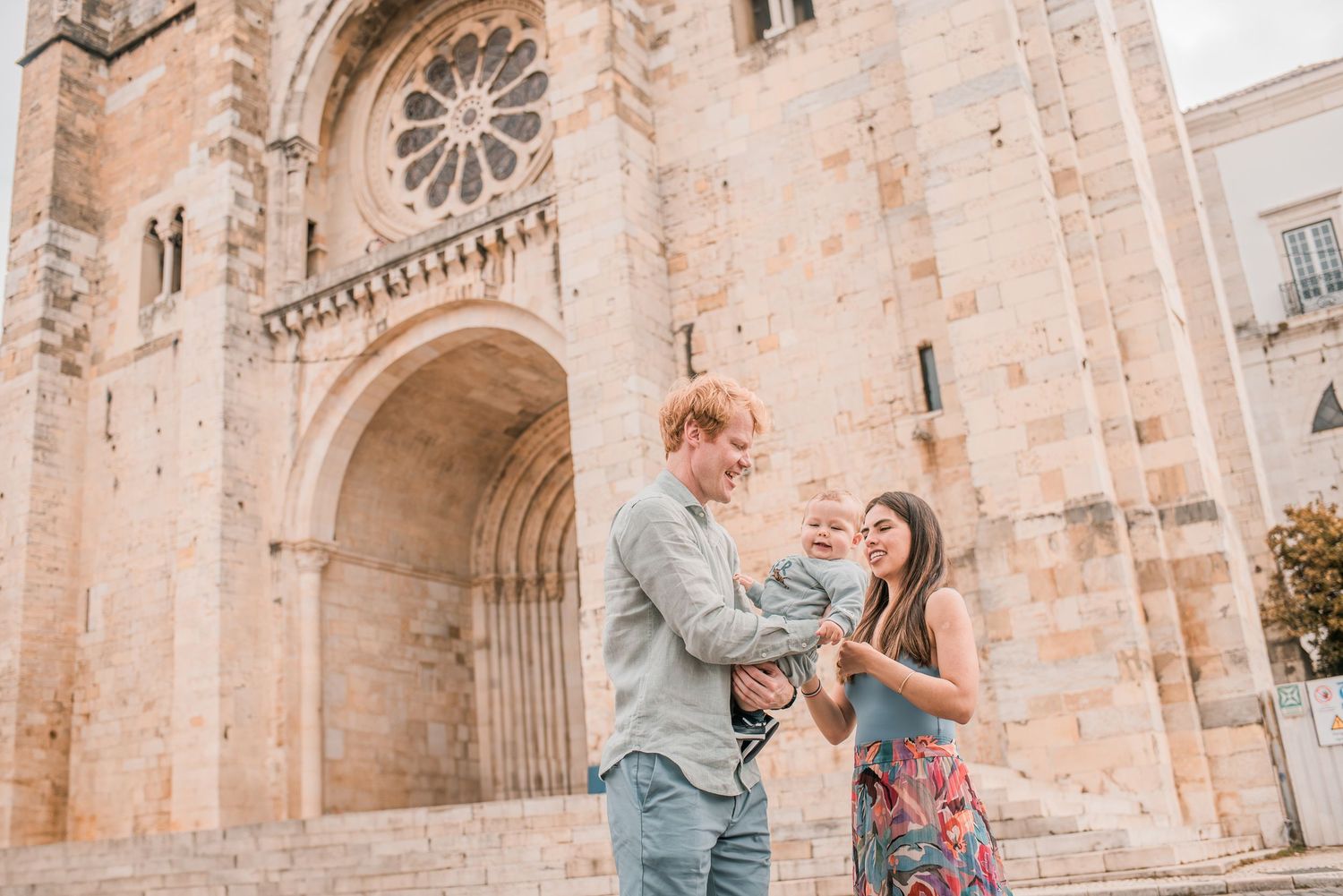 Parents and children sharing a joyful moment during a family session in Lisbon.